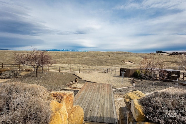 view of yard featuring a rural view and fence