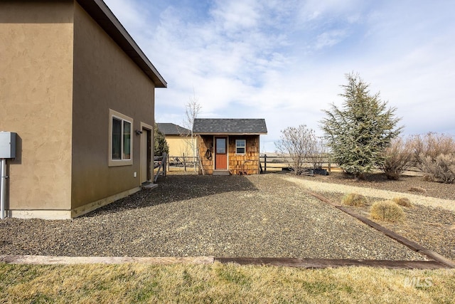 exterior space featuring an outbuilding and fence