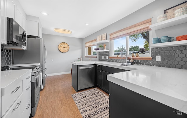 2906 W Kathryn St, Boise, ID 83705 - kitchen with stainless steel appliances, open shelves, backsplash, white cabinetry, and a sink