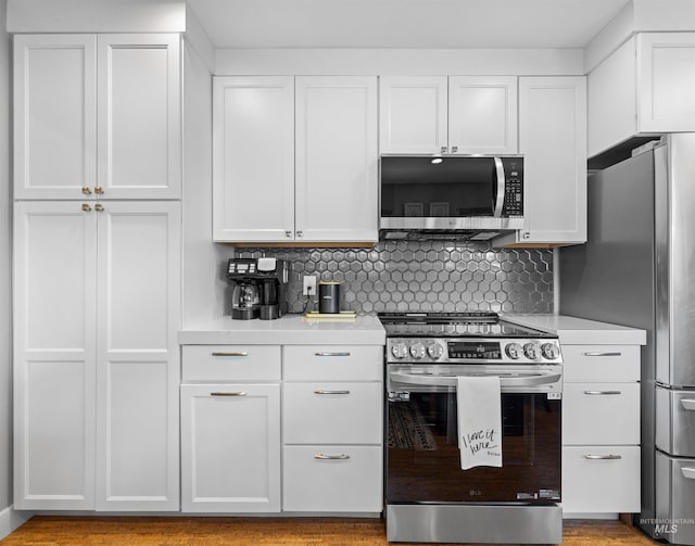 2906 W Kathryn St, Boise, ID 83705 - kitchen with stainless steel appliances, light countertops, white cabinetry, and tasteful backsplash