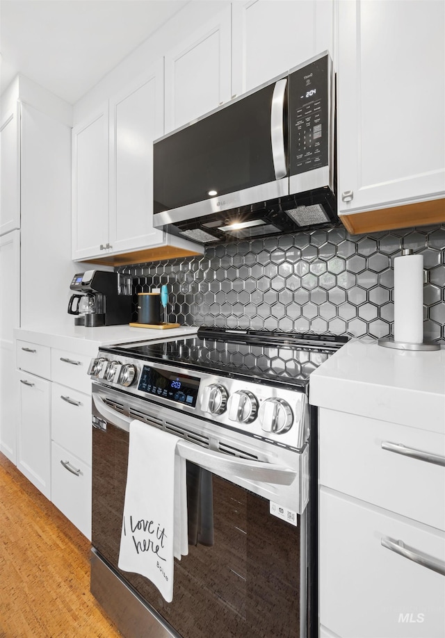 2906 W Kathryn St, Boise, ID 83705 - kitchen with appliances with stainless steel finishes, light countertops, white cabinetry, and backsplash