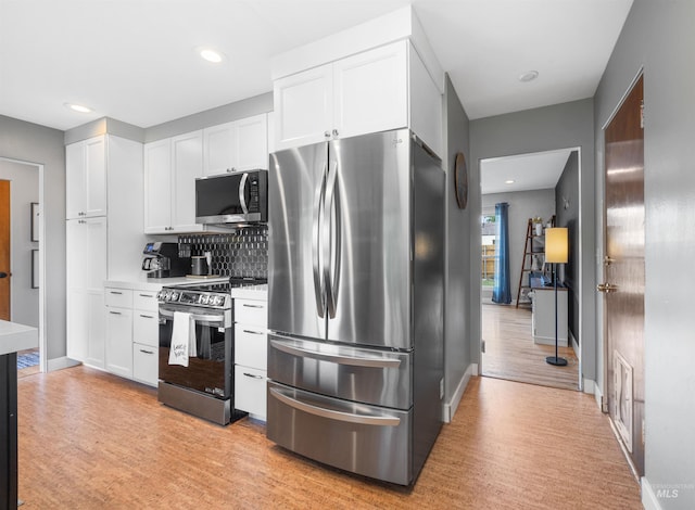 2906 W Kathryn St, Boise, ID 83705 - kitchen featuring appliances with stainless steel finishes, white cabinetry, light wood-style flooring, and recessed lighting