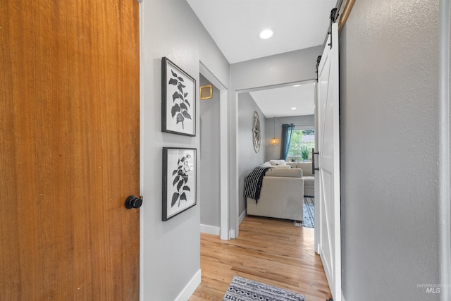 2906 W Kathryn St, Boise, ID 83705 - corridor featuring light wood-type flooring, a barn door, and baseboards