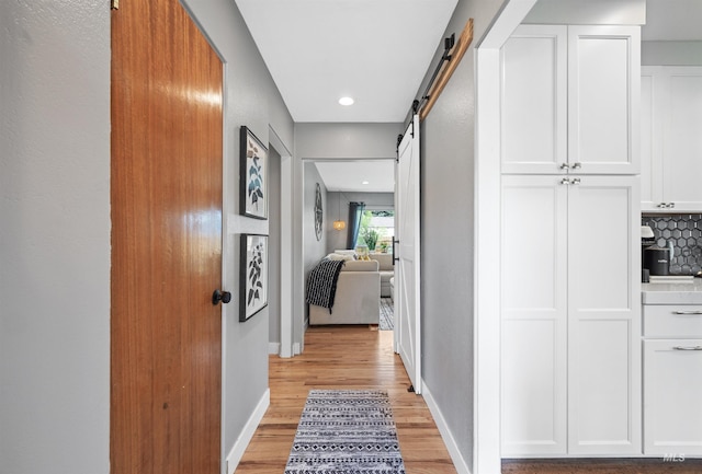 2906 W Kathryn St, Boise, ID 83705 - hall featuring light wood-style flooring, a barn door, recessed lighting, and baseboards