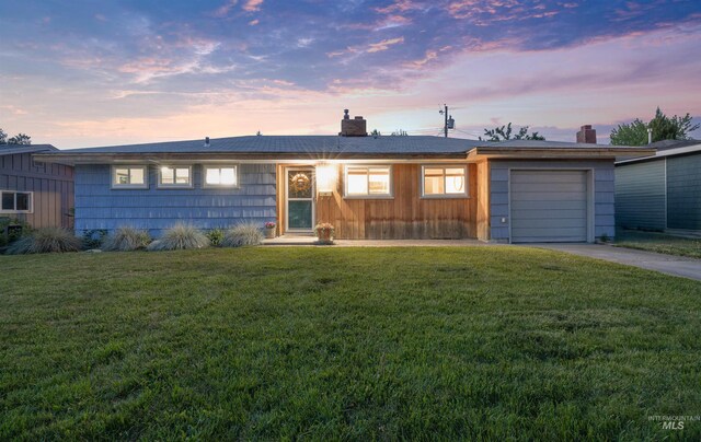 2906 W Kathryn St, Boise, ID 83705 - ranch-style house featuring a chimney, concrete driveway, a garage, and a front yard