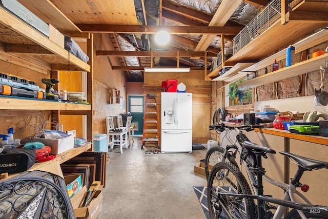 2906 W Kathryn St, Boise, ID 83705 - garage with white fridge with ice dispenser and a workshop area