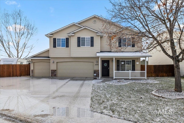 view of front property featuring covered porch and a garage