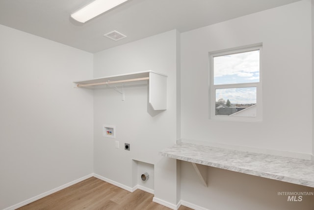 laundry room with electric dryer hookup, washer hookup, and light hardwood / wood-style flooring