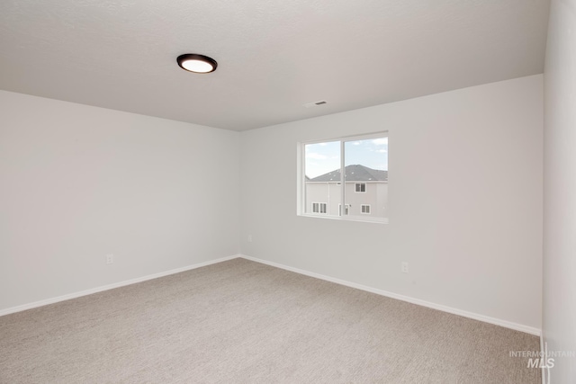 unfurnished room featuring carpet