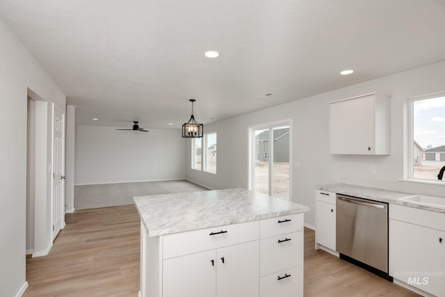 kitchen with pendant lighting, stainless steel dishwasher, white cabinetry, and a center island