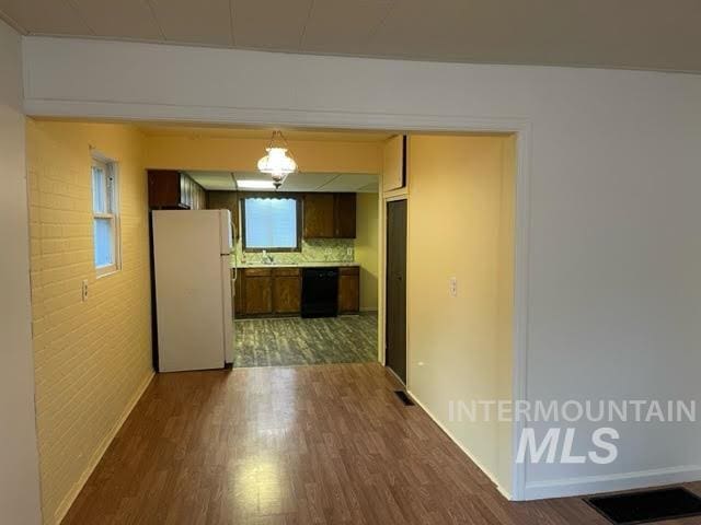 271 Tyler St, Twin Falls, ID 83301 - kitchen with freestanding refrigerator, dark wood finished floors, black dishwasher, and light countertops