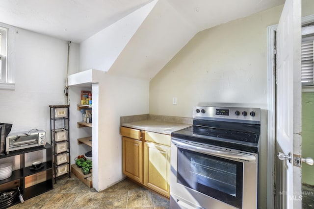 kitchen with lofted ceiling, light countertops, and stainless steel electric range oven