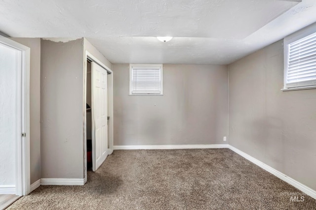 interior space featuring a textured ceiling and baseboards