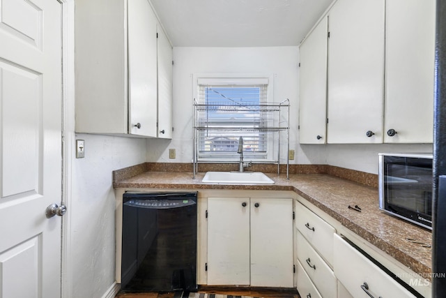 kitchen with white cabinets, a sink, and black appliances