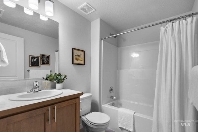 full bathroom with vanity, a textured ceiling, decorative backsplash, toilet, and shower / bath combo with shower curtain