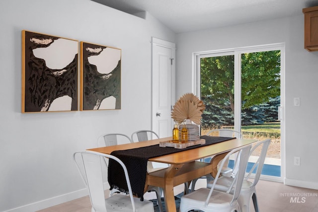 dining room with vaulted ceiling