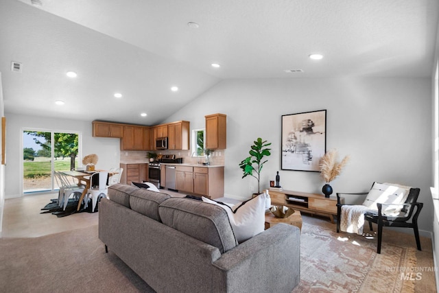 living room featuring light carpet, sink, and vaulted ceiling