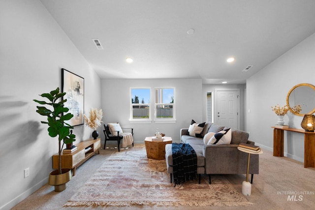 carpeted living room with vaulted ceiling