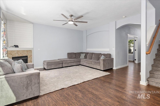 6495 S Mistyglen Ave, Boise, ID 83709 - living room featuring arched walkways, ceiling fan, stairway, and wood finished floors