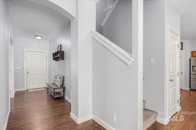 6495 S Mistyglen Ave, Boise, ID 83709 - hallway with arched walkways, wood finished floors, stairs, and baseboards