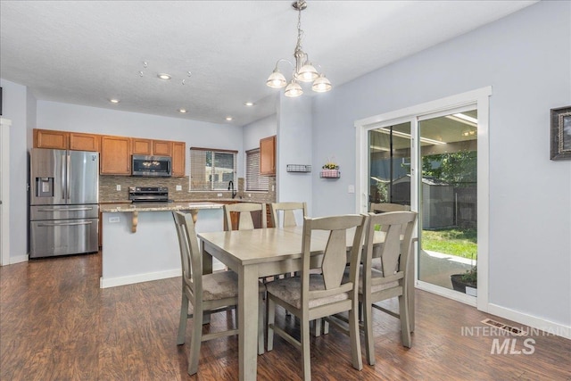 6495 S Mistyglen Ave, Boise, ID 83709 - dining room featuring dark wood-style flooring, a chandelier, recessed lighting, and baseboards