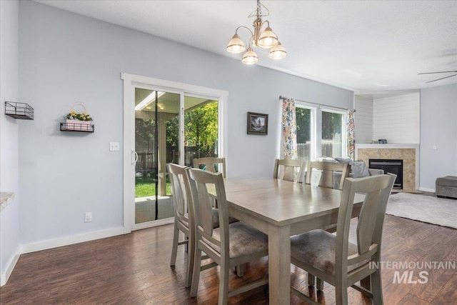 6495 S Mistyglen Ave, Boise, ID 83709 - dining space with dark wood finished floors, a premium fireplace, baseboards, and a chandelier
