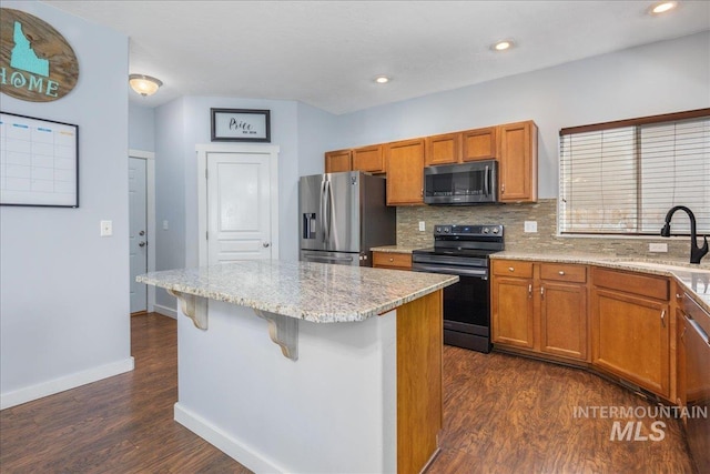 6495 S Mistyglen Ave, Boise, ID 83709 - kitchen with electric range, stainless steel refrigerator with ice dispenser, a sink, dark wood-style flooring, and a center island