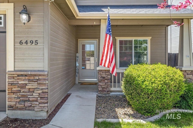 6495 S Mistyglen Ave, Boise, ID 83709 - entrance to property with stone siding and a shingled roof