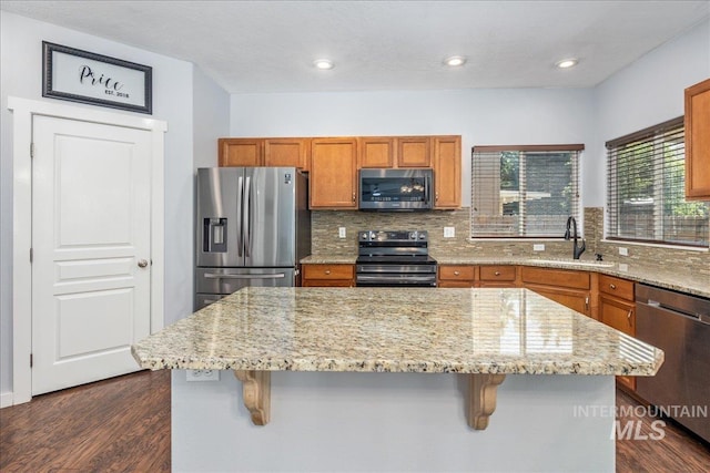 6495 S Mistyglen Ave, Boise, ID 83709 - kitchen featuring stainless steel appliances, a sink, dark wood-type flooring, decorative backsplash, and recessed lighting