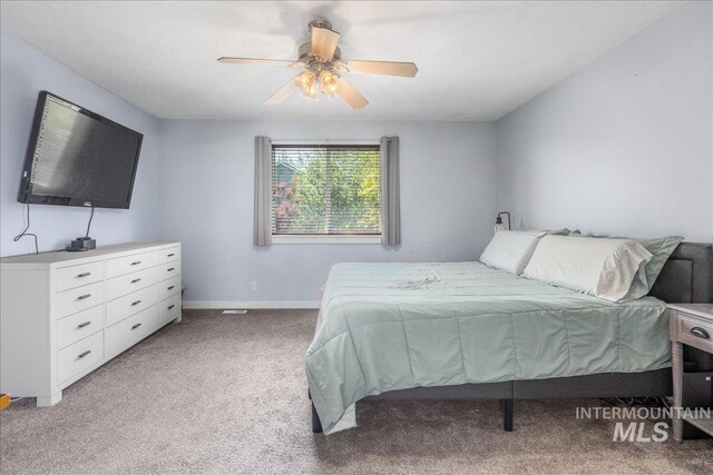 6495 S Mistyglen Ave, Boise, ID 83709 - bedroom featuring light carpet, baseboards, and a ceiling fan