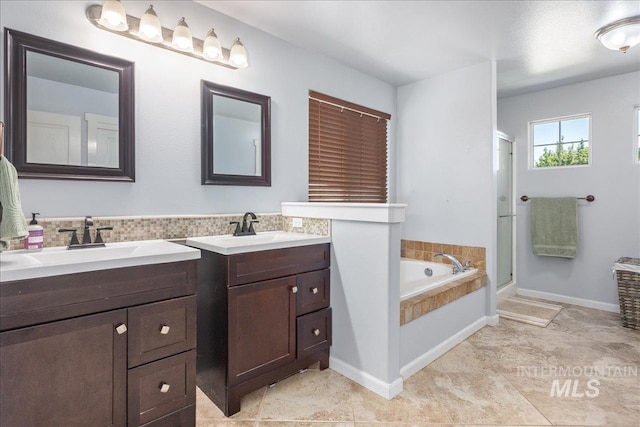 6495 S Mistyglen Ave, Boise, ID 83709 - full bathroom featuring two vanities, a shower stall, a bath, and tile patterned flooring