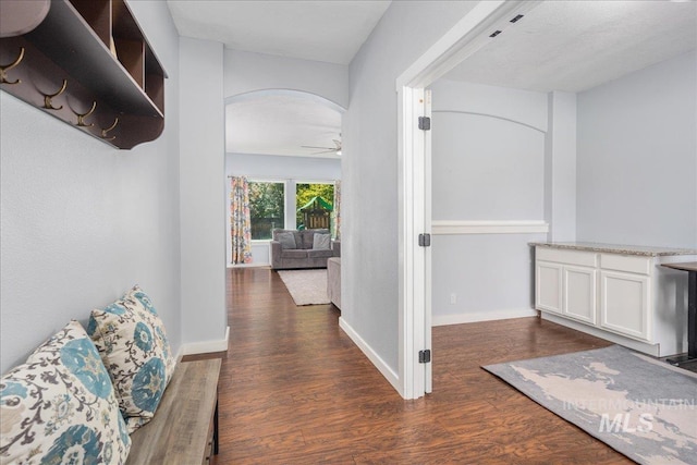6495 S Mistyglen Ave, Boise, ID 83709 - corridor with arched walkways, wood finished floors, and baseboards