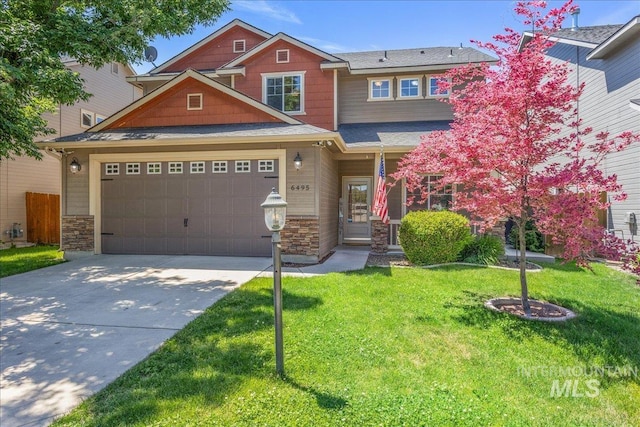 6495 S Mistyglen Ave, Boise, ID 83709 - craftsman-style house featuring concrete driveway, a front lawn, stone siding, and a garage