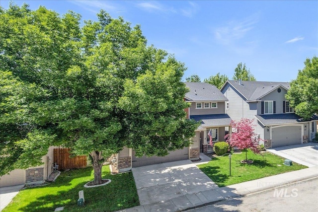 6495 S Mistyglen Ave, Boise, ID 83709 - view of front facade featuring driveway, stone siding, and an attached garage