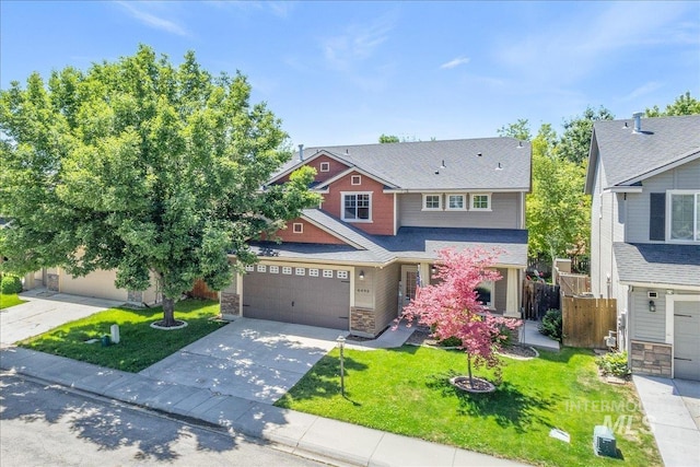 6495 S Mistyglen Ave, Boise, ID 83709 - craftsman-style house featuring stone siding, concrete driveway, and a shingled roof