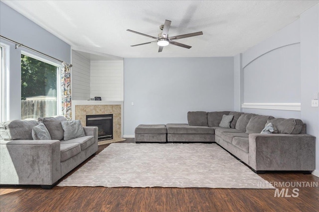 6495 S Mistyglen Ave, Boise, ID 83709 - living area with a ceiling fan, a tiled fireplace, and wood finished floors
