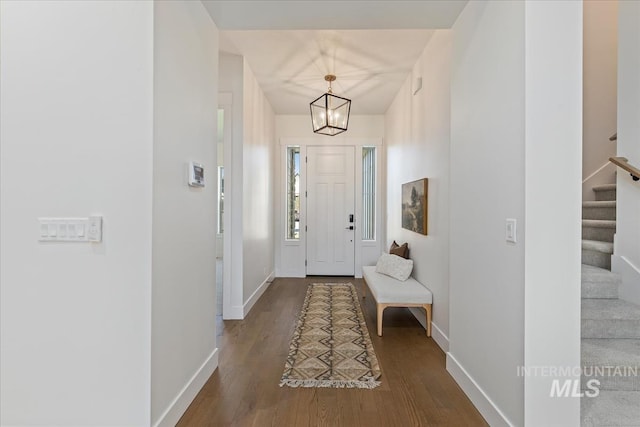 entrance foyer with wood-type flooring and an inviting chandelier