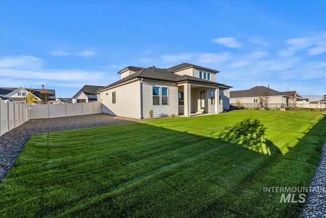 back of property featuring a lawn