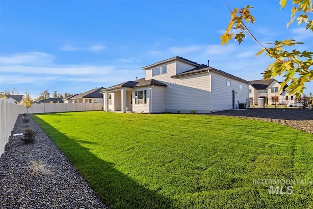 rear view of property featuring a yard