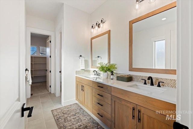 bathroom with backsplash, vanity, and tile patterned flooring