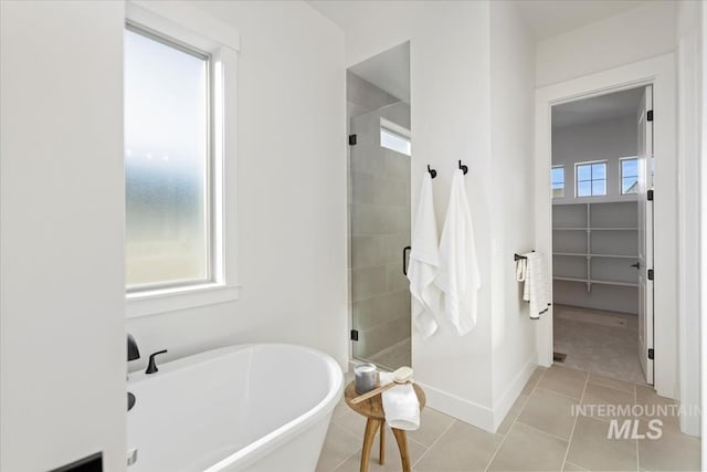 bathroom with independent shower and bath and tile patterned flooring