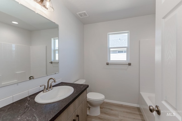 full bath with toilet, a healthy amount of sunlight, vanity, and visible vents