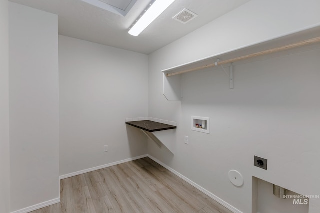 laundry area with light wood-style flooring, baseboards, hookup for a washing machine, hookup for an electric dryer, and laundry area