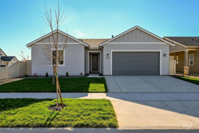 ranch-style home featuring driveway, an attached garage, fence, a front lawn, and board and batten siding