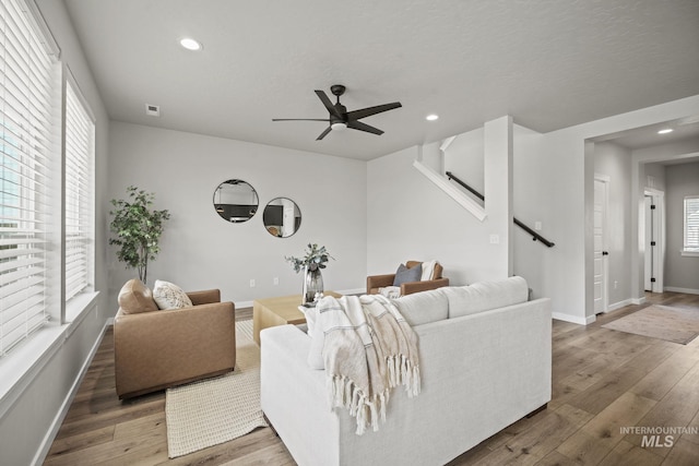 10061 W La Jolla Dr, Boise, ID 83709 - living area with recessed lighting, ceiling fan, wood finished floors, and stairs
