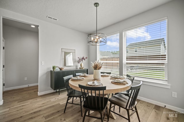 10061 W La Jolla Dr, Boise, ID 83709 - dining area featuring light wood-type flooring, a chandelier, and recessed lighting