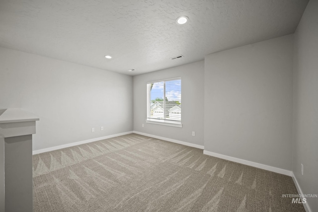 10061 W La Jolla Dr, Boise, ID 83709 - empty room featuring carpet, a textured ceiling, and recessed lighting