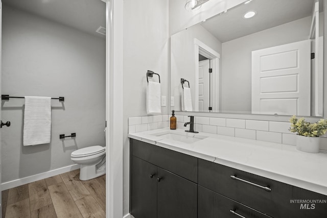 10061 W La Jolla Dr, Boise, ID 83709 - bathroom with vanity, wood finished floors, and recessed lighting