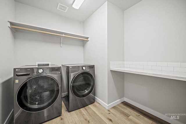 10061 W La Jolla Dr, Boise, ID 83709 - laundry room with washer and dryer and light wood-style floors
