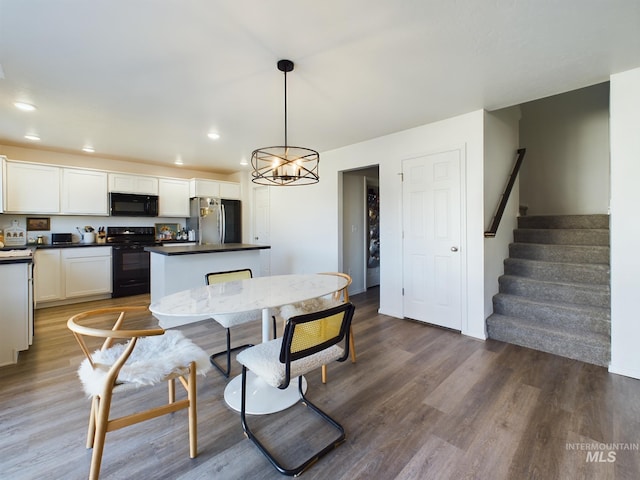 dining room featuring dark hardwood / wood-style floors and a notable chandelier